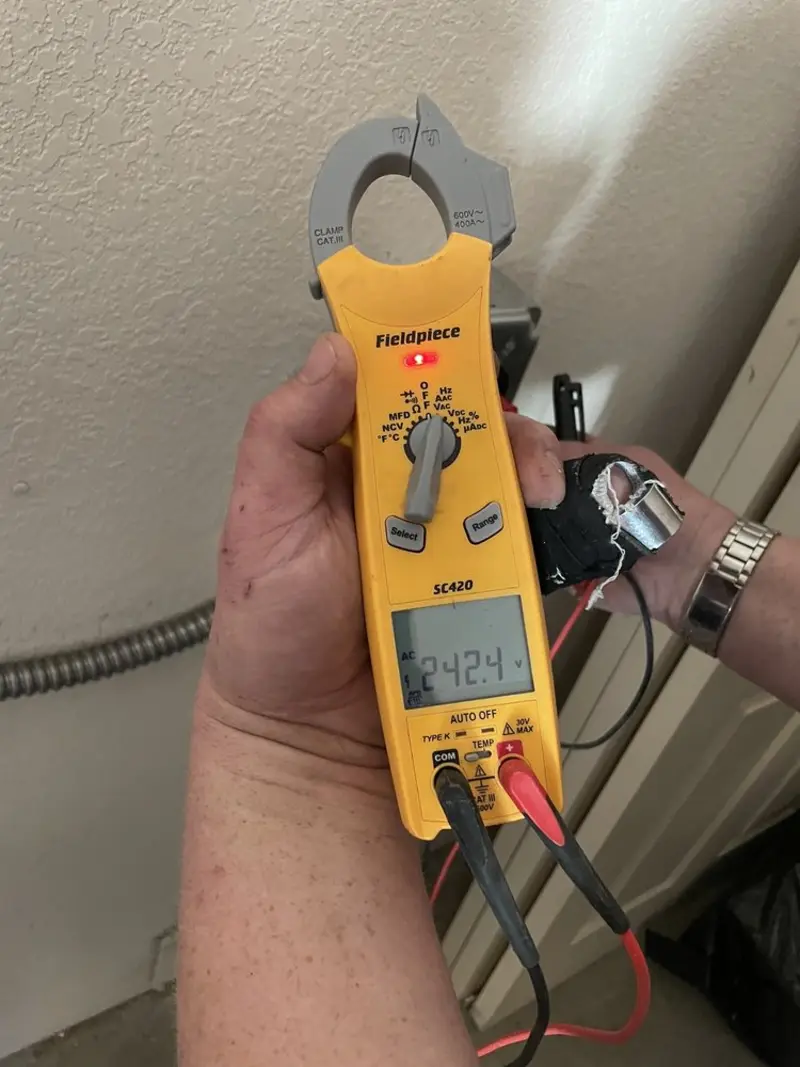Voltage testing with clamp meter during Recessed Lighting Installation in Carrollton